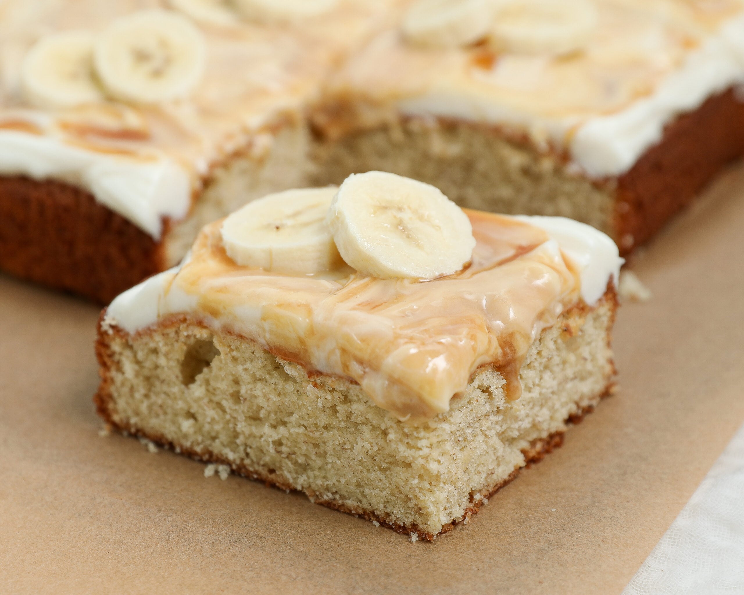 Honey banana cake with cream cheese frosting, honey drizzle, walnuts and fresh banana slices