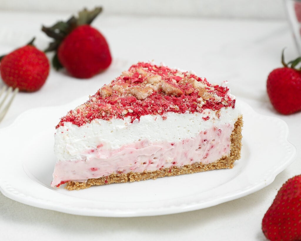 Easy strawberry shortcake cheesecake is a creamy baked cheesecake with strawberry flavor, a vanilla wafer crust, and a sweet strawberry crunch topping.
