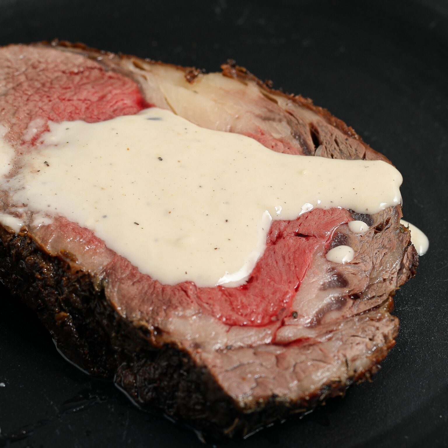 Prime Rib with Roasted Garlic Parmesan Cream Sauce - The Salty Cooker