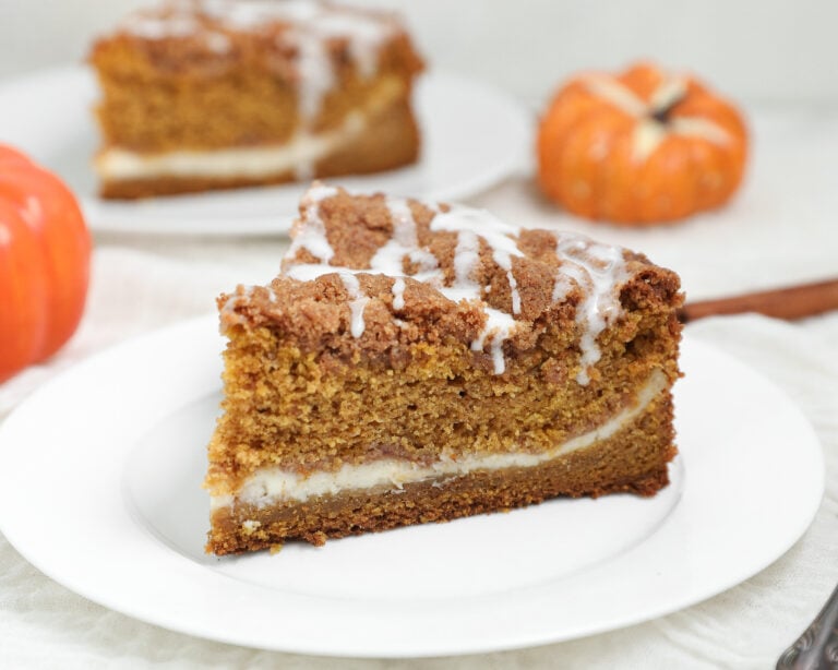 Pumpkin Coffee Cake with Cream Cheese is the perfect fall breakfast or dessert made with moist pumpkin cake, a rich cream cheese filling, buttery cinnamon pecan streusel, and a simple vanilla glaze.