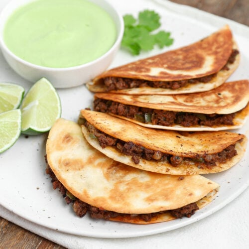 Plated Cheesy Crispy Beef Tacos with Avocado Cilantro Sauce