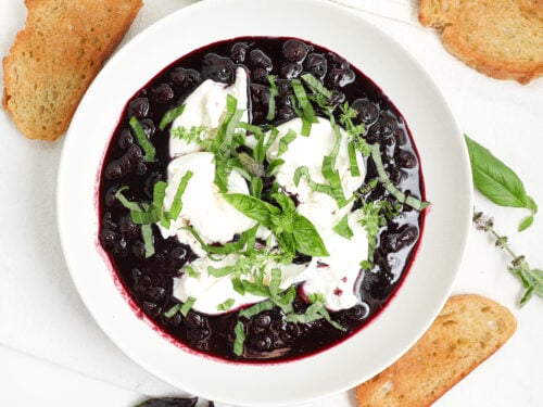 Blueberry burrata bruschetta with balsamic blueberries, basil, and toasted crostini.