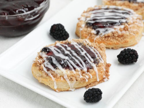 This easy Berry Cream Cheese Danish is made with flaky biscuits, sweet cream cheese filling, berry pie filling, buttery crumble topping, and a simple glaze. Perfect for breakfast, brunch, holidays, or dessert.