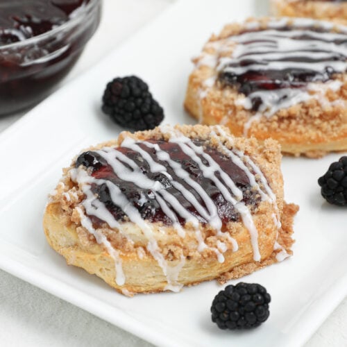 This easy Berry Cream Cheese Danish is made with flaky biscuits, sweet cream cheese filling, berry pie filling, buttery crumble topping, and a simple glaze. Perfect for breakfast, brunch, holidays, or dessert.