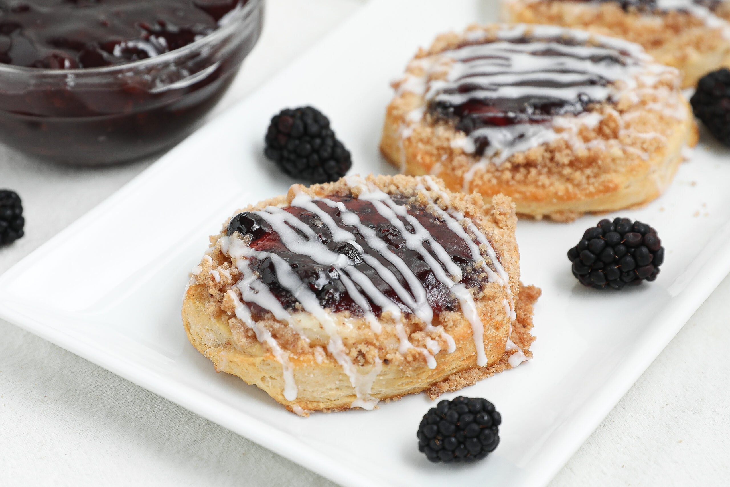 This easy Berry Cream Cheese Danish is made with flaky biscuits, sweet cream cheese filling, berry pie filling, buttery crumble topping, and a simple glaze. Perfect for breakfast, brunch, holidays, or dessert.