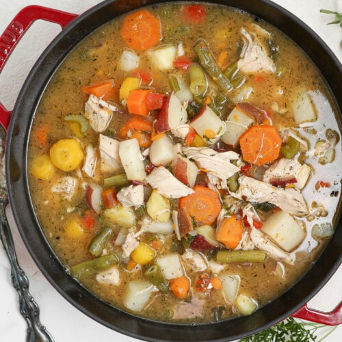 Easy chicken stew with tender chicken, potatoes, carrots, green beans, and kale in a flavorful broth