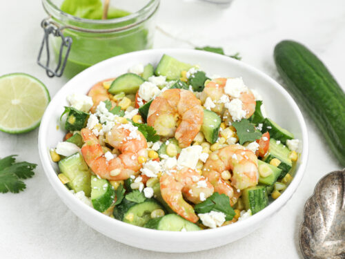 Shrimp cucumber corn salad with roasted shrimp, corn, cucumber, feta, and cilantro vinaigrette.
