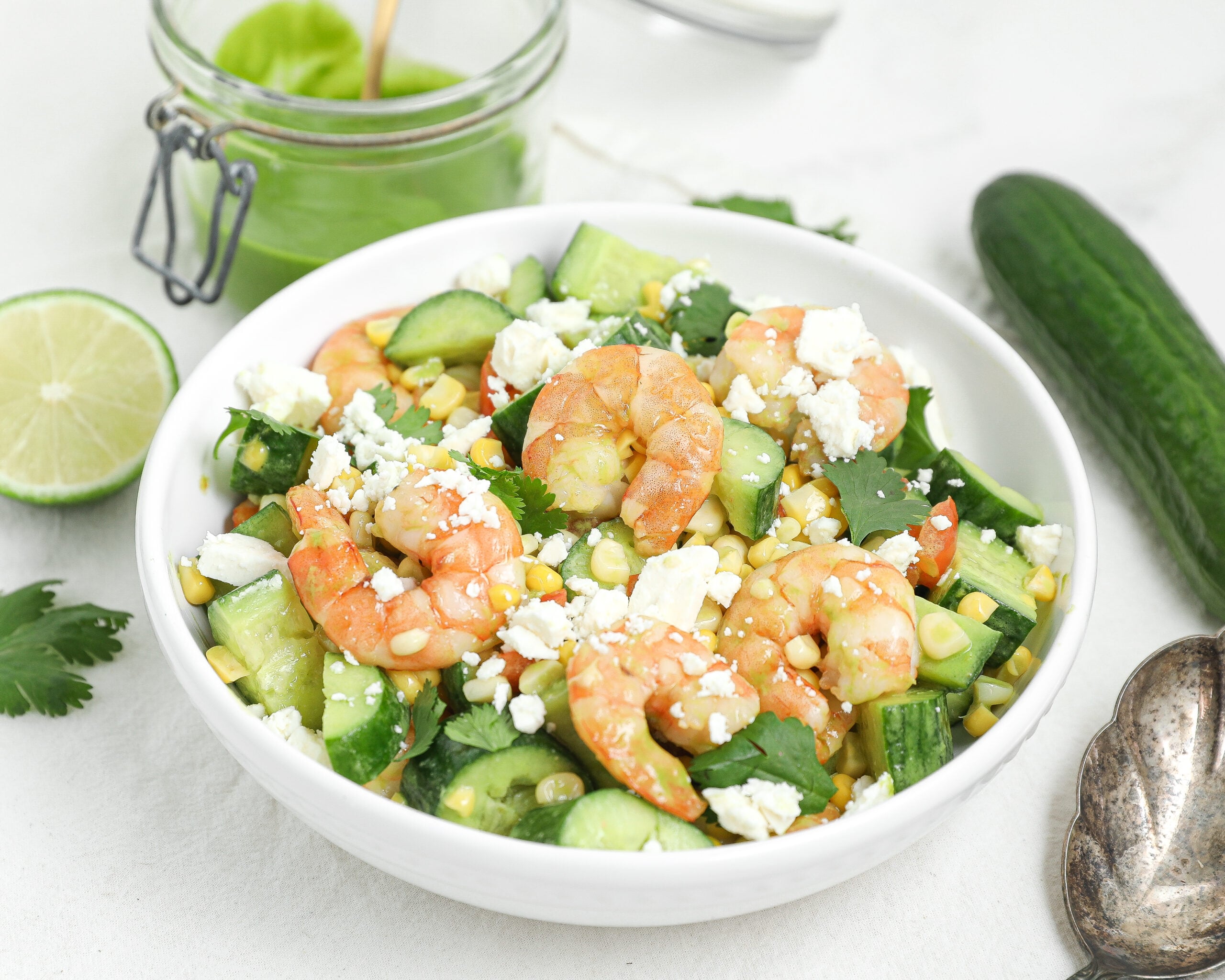 Shrimp cucumber corn salad with roasted shrimp, corn, cucumber, feta, and cilantro vinaigrette.