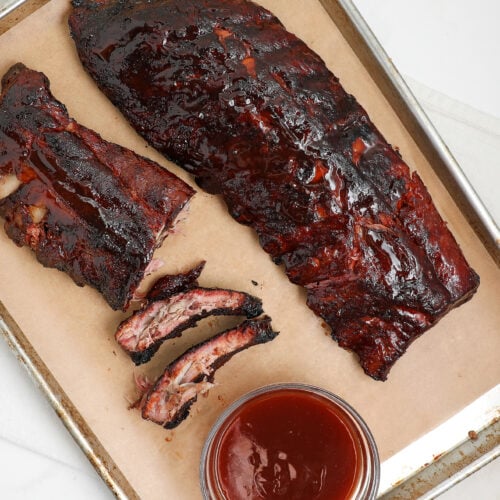 Smoked BBQ ribs glazed with barbecue sauce and sliced between the bones.
