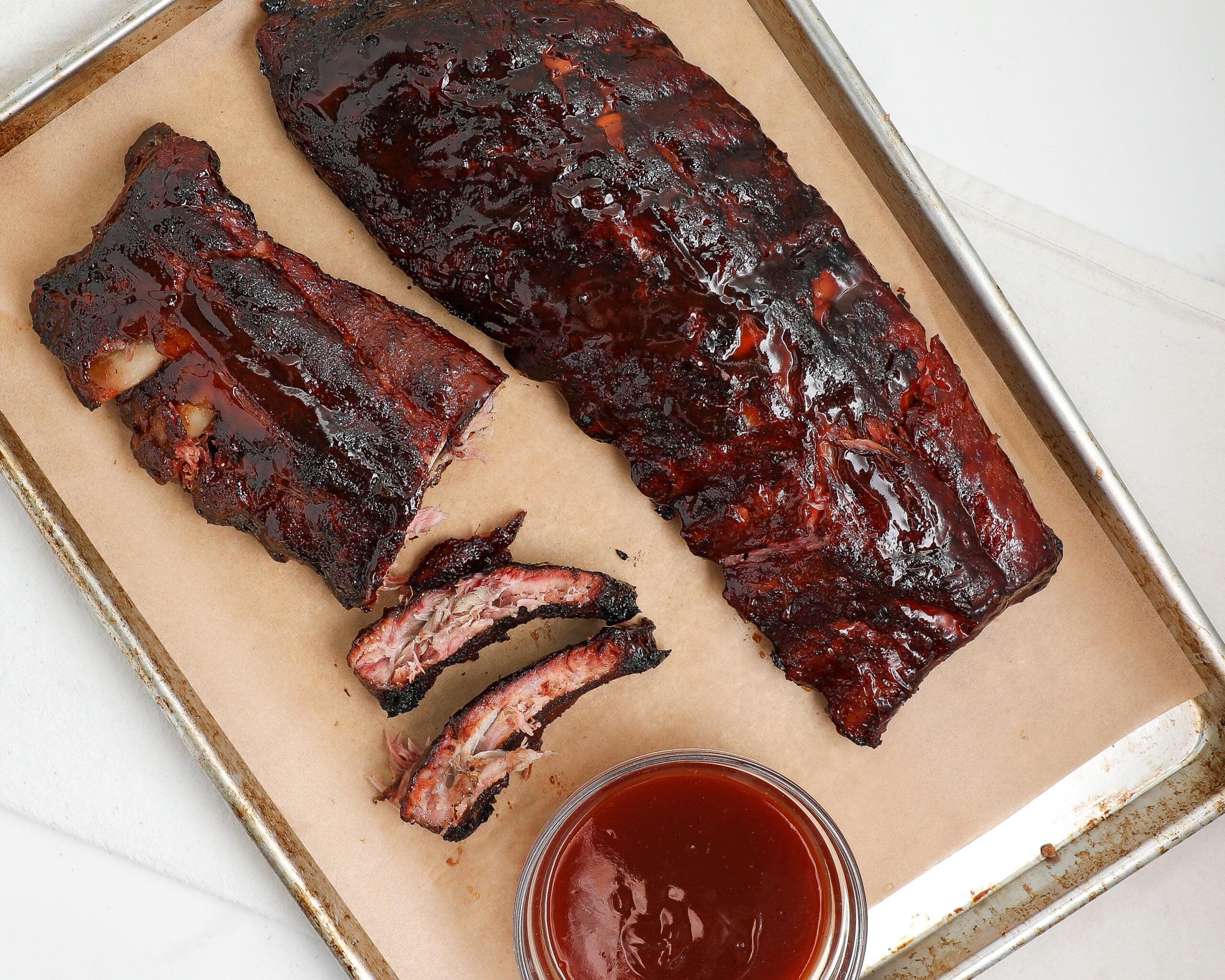 Smoked BBQ ribs glazed with barbecue sauce and sliced between the bones.