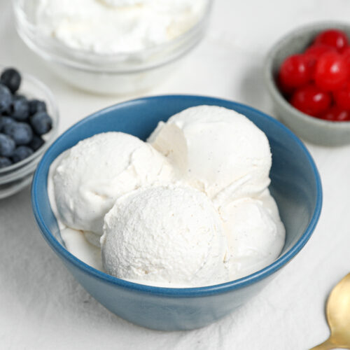 Homemade Vanilla Ice Cream is rich, creamy, and made with simple ingredients including cream, milk, egg yolks, sugar, and vanilla.