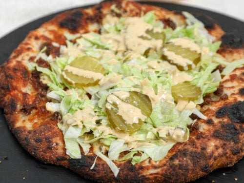 Big Mac Pizza topped with homemade Big Mac sauce, shredded lettuce, dill pickles, and ground beef on a crispy homemade pizza crust.
