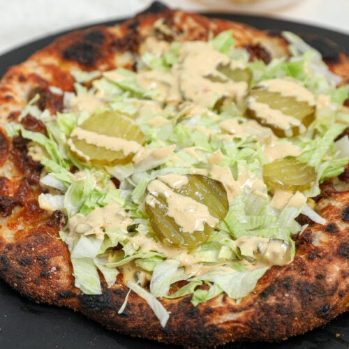 Big Mac Pizza topped with homemade Big Mac sauce, shredded lettuce, dill pickles, and ground beef on a crispy homemade pizza crust.