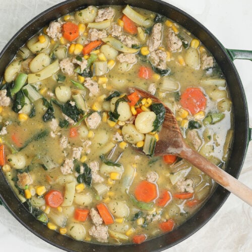 Creamy chicken gnocchi with tender chicken, potato gnocchi, carrots, corn, kale, and herbs in a creamy broth.