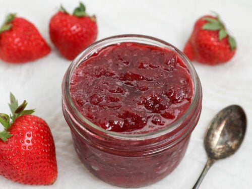 Homemade 3 ingredient strawberry jam made with fresh strawberries in a glass mason jar.