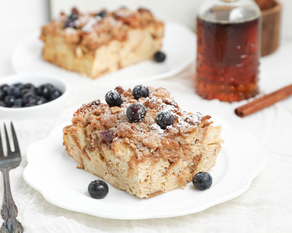 French Toast Casserole baked until golden brown with a buttery cinnamon crumb topping in a white baking dish.