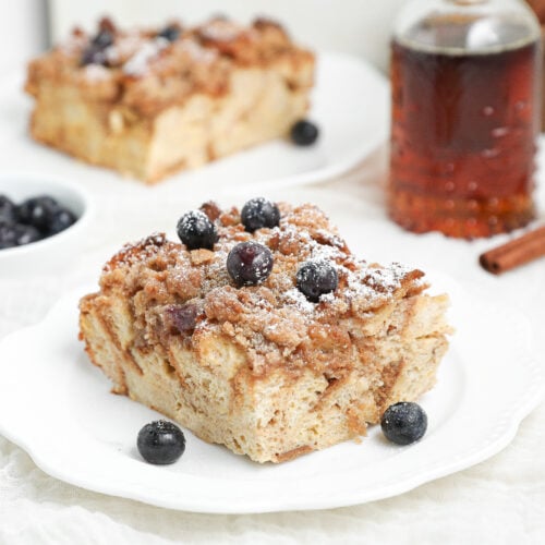 French Toast Casserole baked until golden brown with a buttery cinnamon crumb topping in a white baking dish.