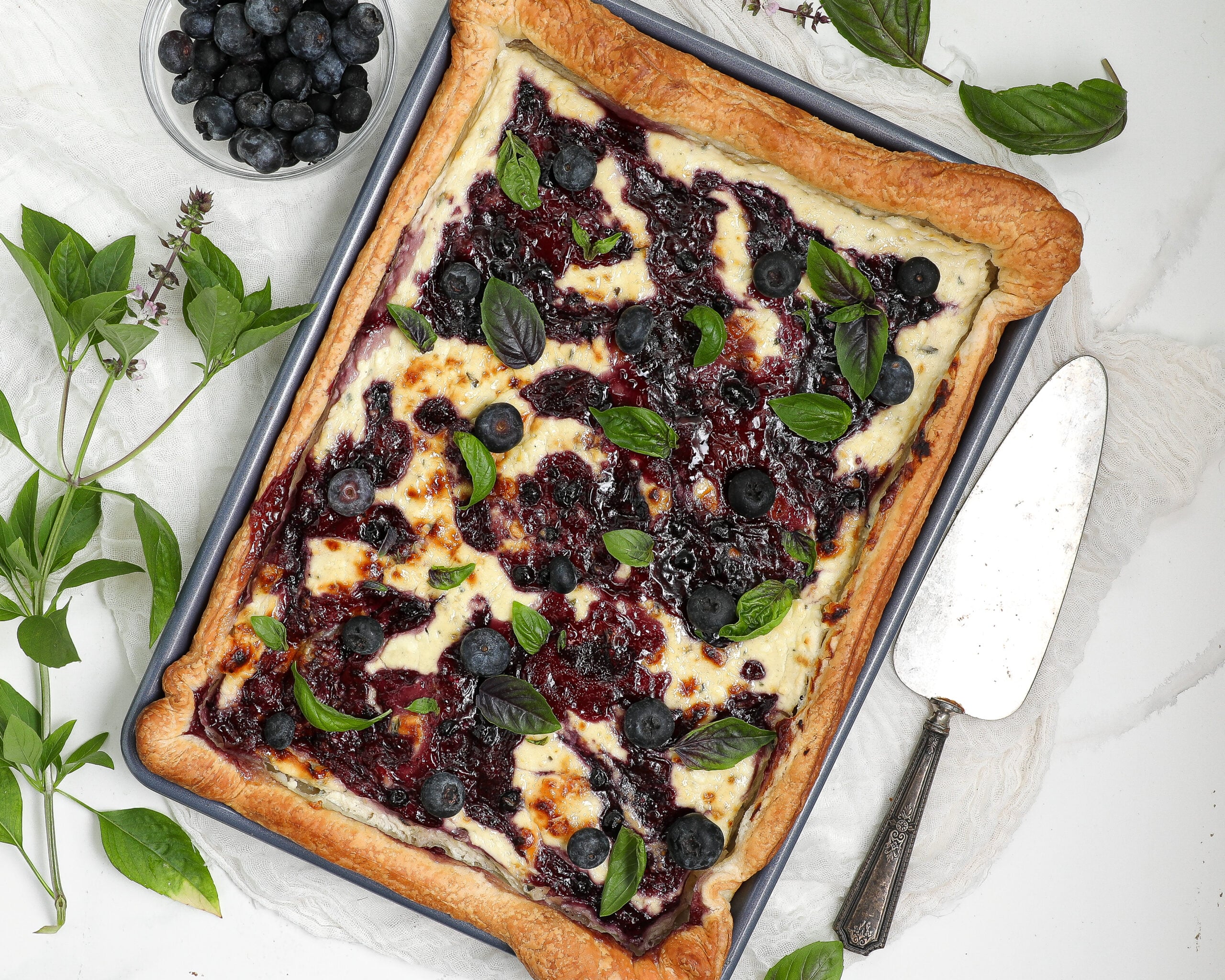 Blueberry Blue Cheese Tart with puff pastry, blueberry jam, fresh blueberries, and basil.