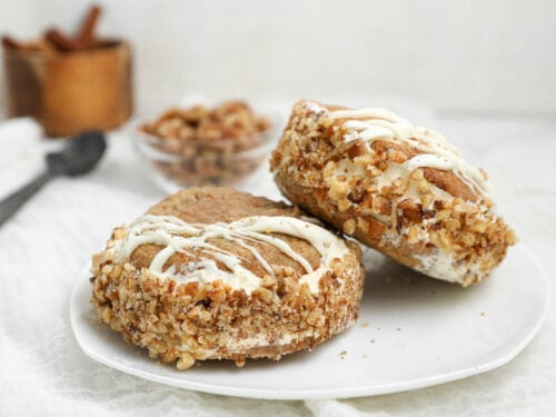 Carrot cake cookie ice cream sandwiches with cream cheese ice cream, toasted walnuts and white chocolate drizzle