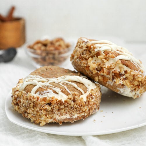 Carrot cake cookie ice cream sandwiches with cream cheese ice cream, toasted walnuts and white chocolate drizzle