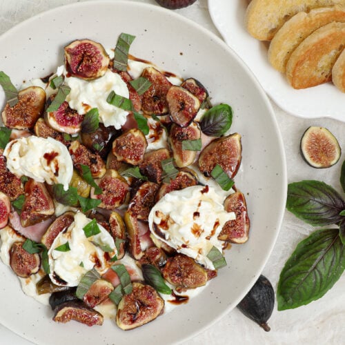Roasted Fig Burrata Dip with fresh figs, creamy burrata, prosciutto, honey ricotta, balsamic glaze and fresh basil served with toasted bread.