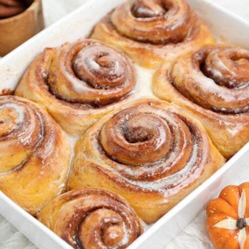 Small batch pumpkin cinnamon rolls with pumpkin spice brown sugar filling baked until golden and gooey.