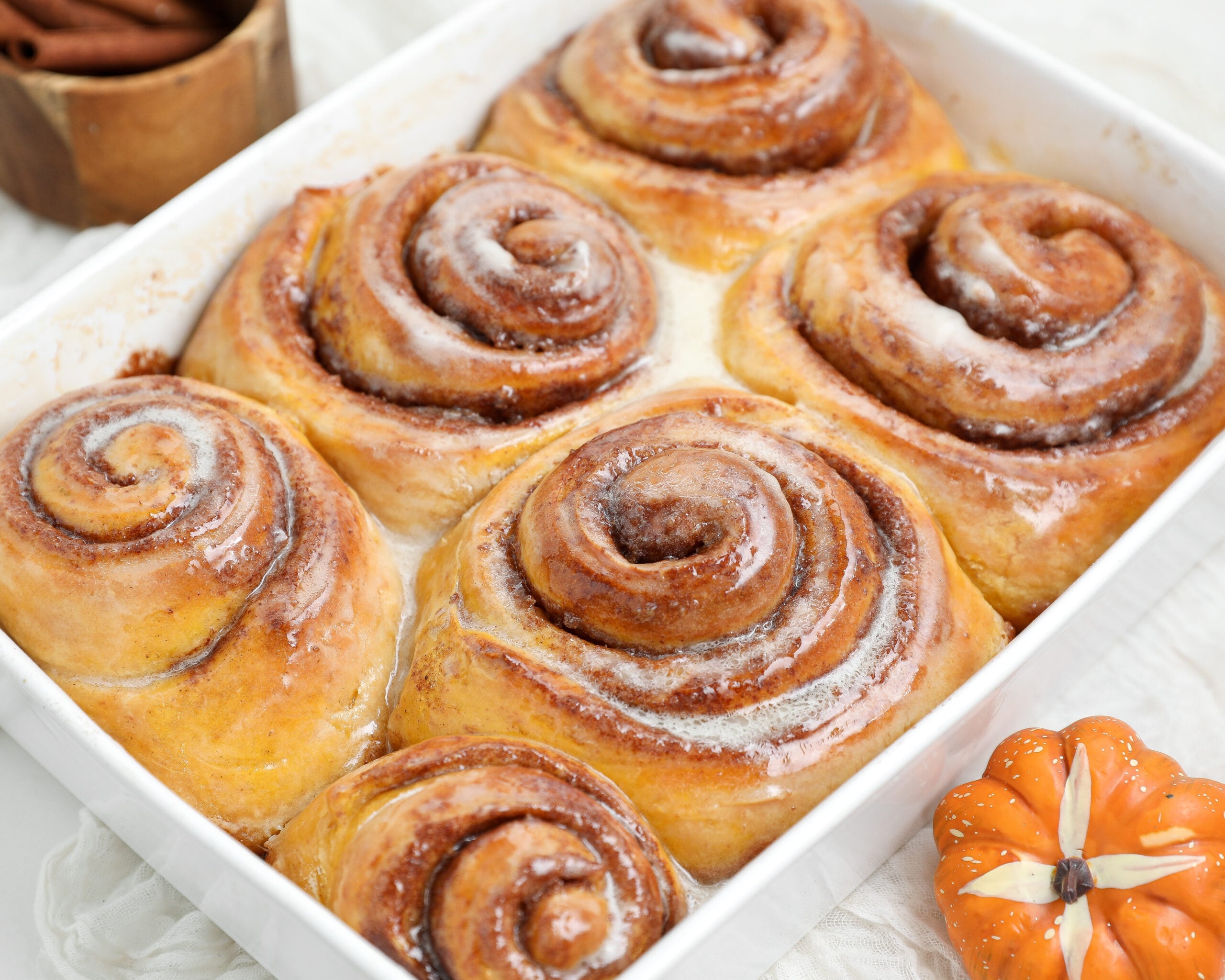 Small batch pumpkin cinnamon rolls with pumpkin spice brown sugar filling baked until golden and gooey.
