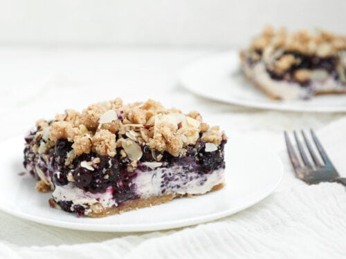 Berry Cottage Cheesecake Bars with creamy cottage cheese filling, berry chia jam, almond shortbread crust, and almond crumble topping.