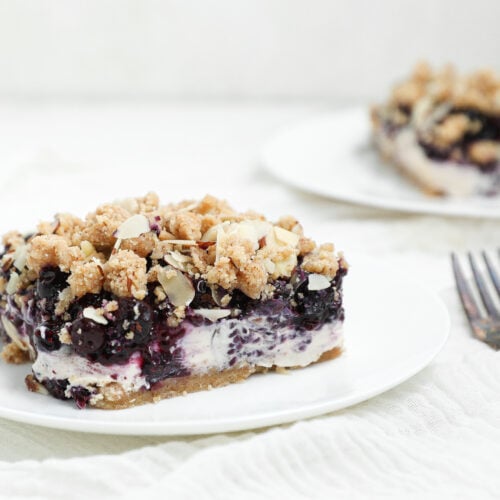 Berry Cottage Cheesecake Bars with creamy cottage cheese filling, berry chia jam, almond shortbread crust, and almond crumble topping.