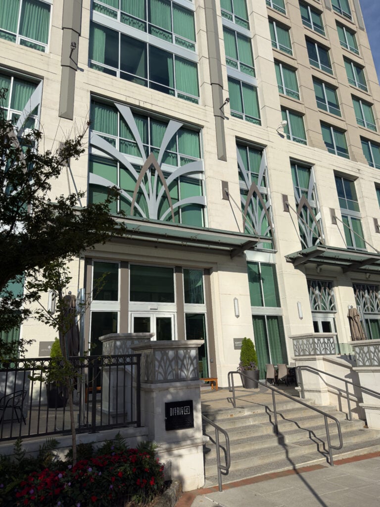 Street-level entrance and tall windows at Kimpton Hotel Arras in downtown Asheville.