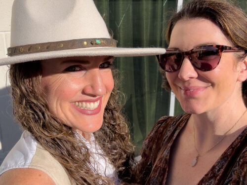 Two friends smiling together during an Asheville birthday getaway.