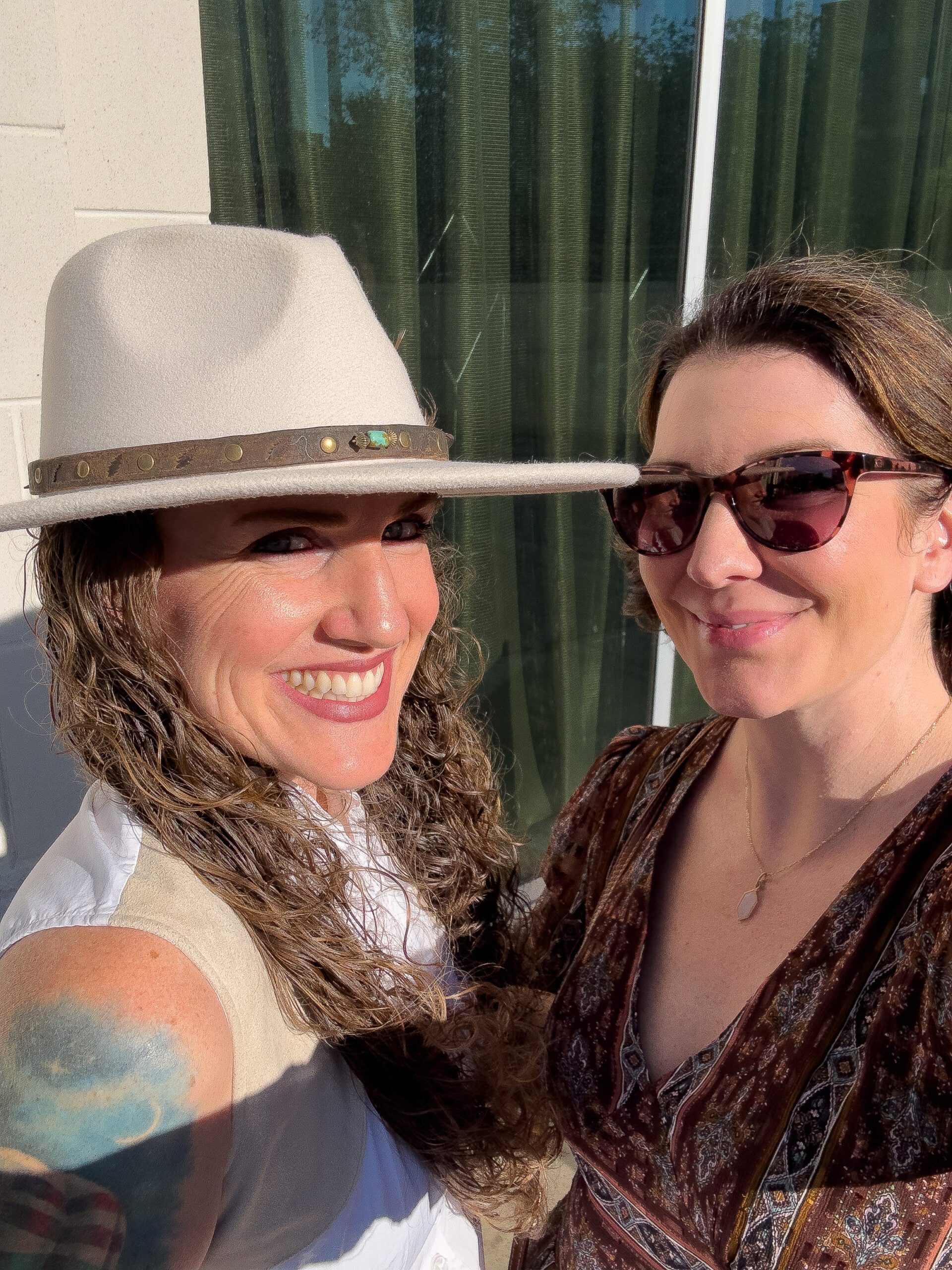 Two friends smiling together during an Asheville birthday getaway.